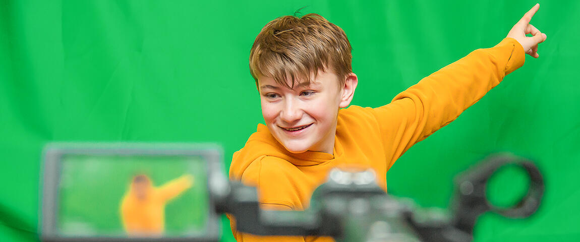 A Middle School Student in Front of a Green Screen